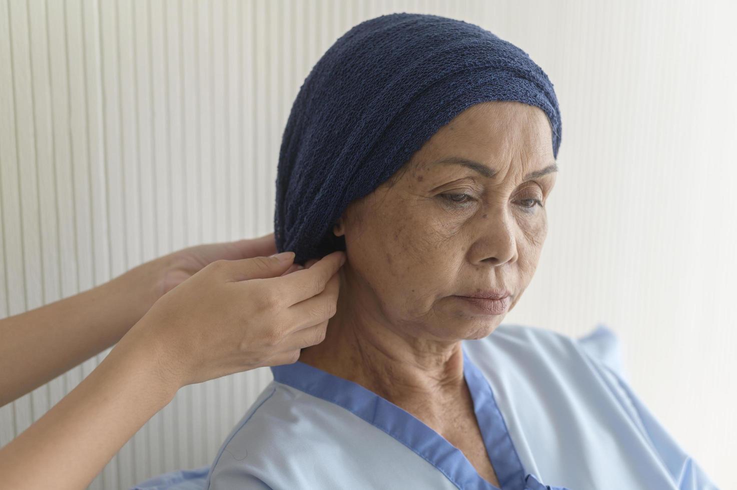 Portrait of senior cancer patient woman wearing head scarf in hospital, healthcare and medical concept photo