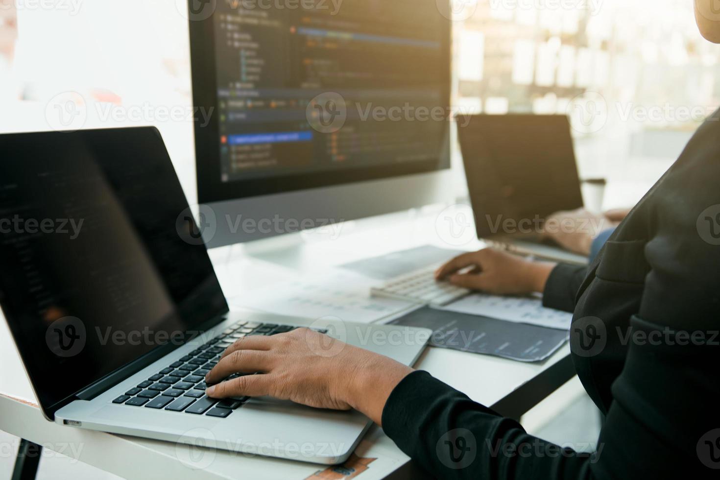 Professional development programmer cooperating meeting programming website working a software in office room. photo