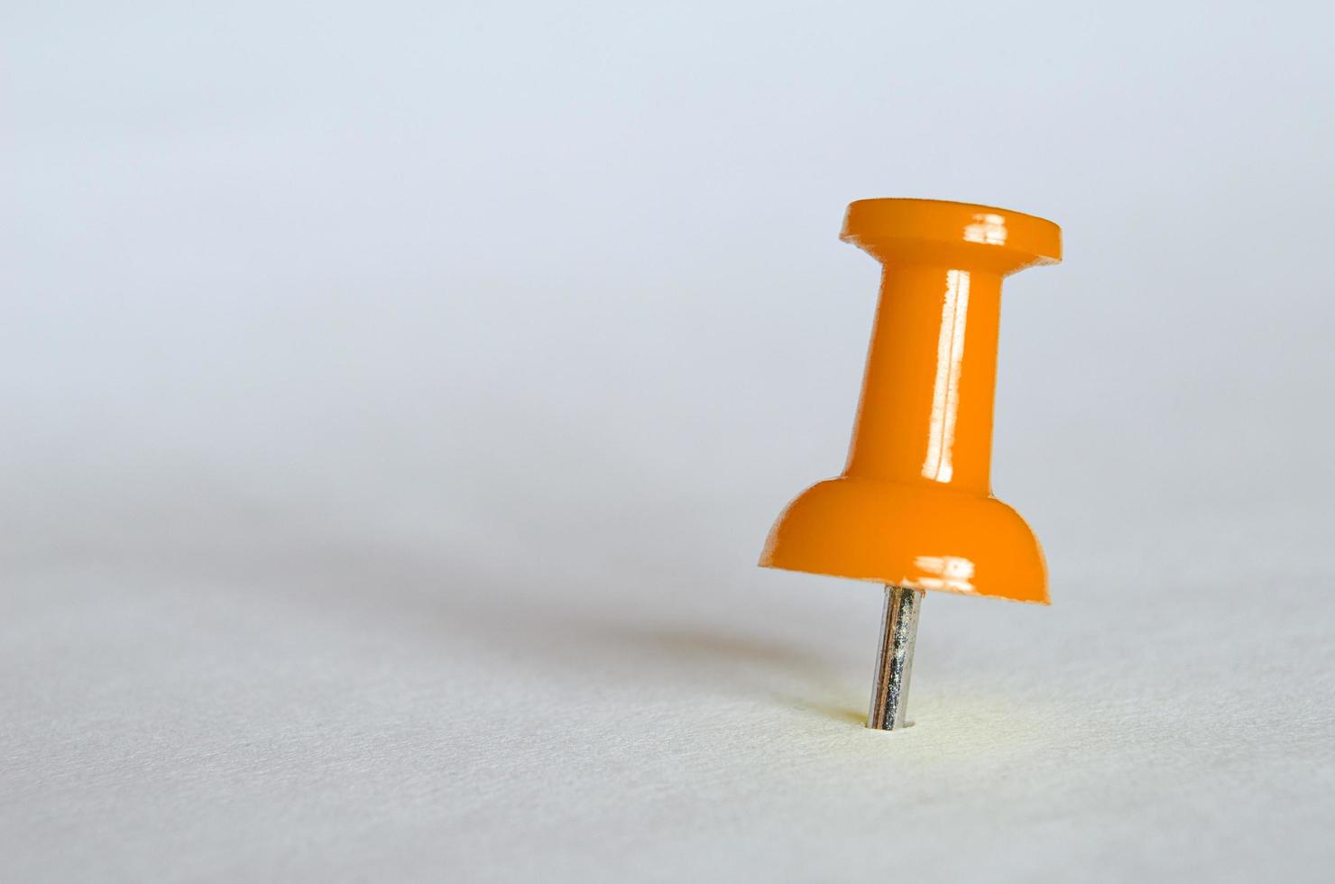 Orange push pin. Closeup photography of orange thumbtack photo