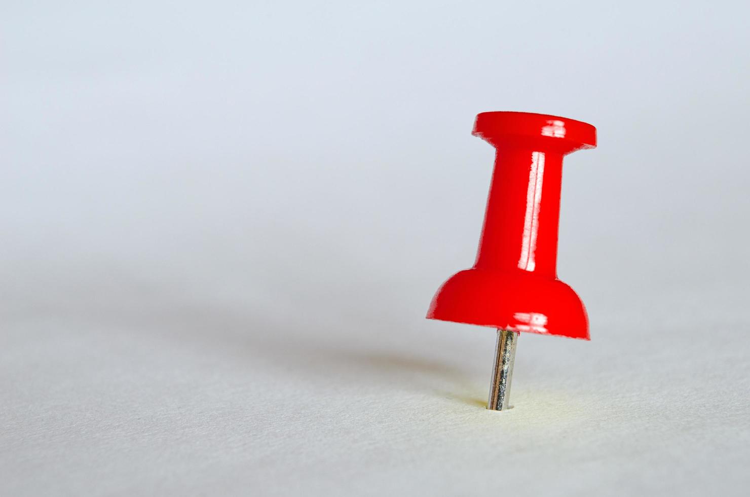 Red push pin. Closeup photography of red thumbtack photo