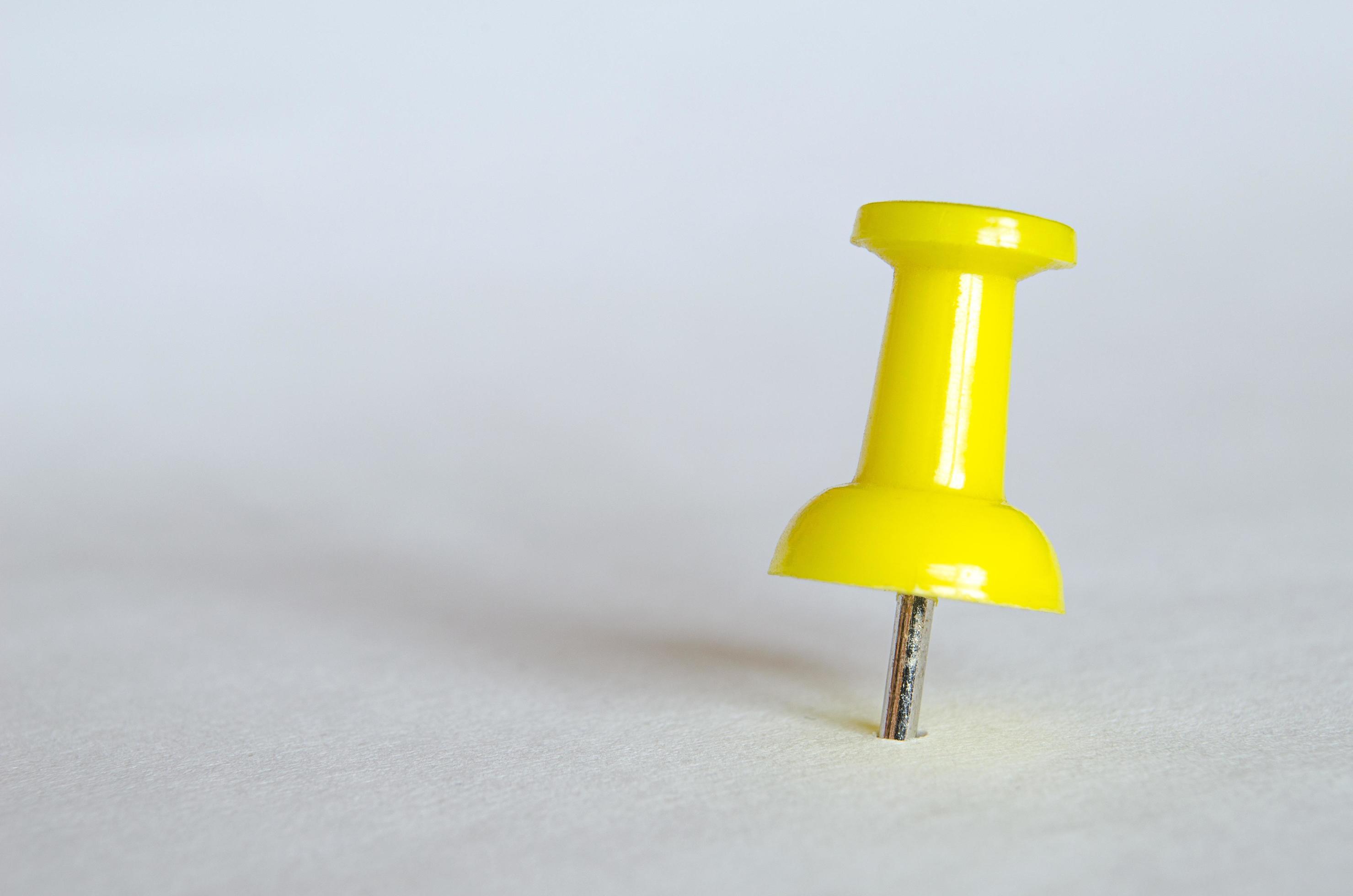 Yellow push pin. Closeup photography of yellow thumbtack 6064861 Stock