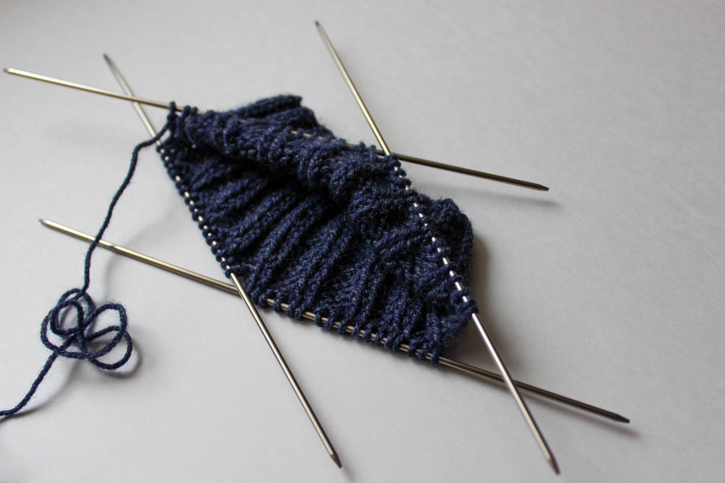 Yarn and knitting needles on white background. Handmade process photo