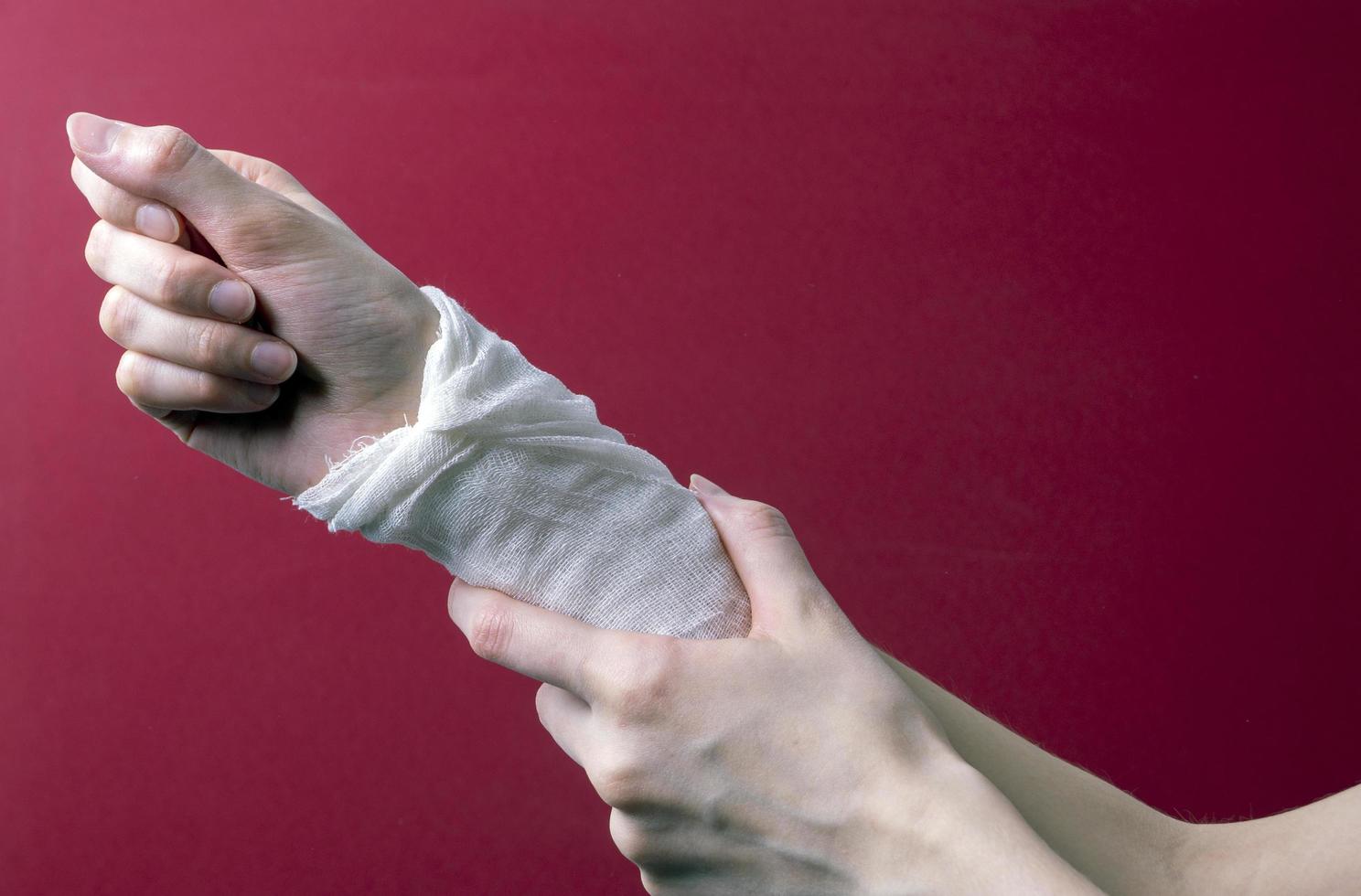 woman's hand bandaged with a medical bandage photo