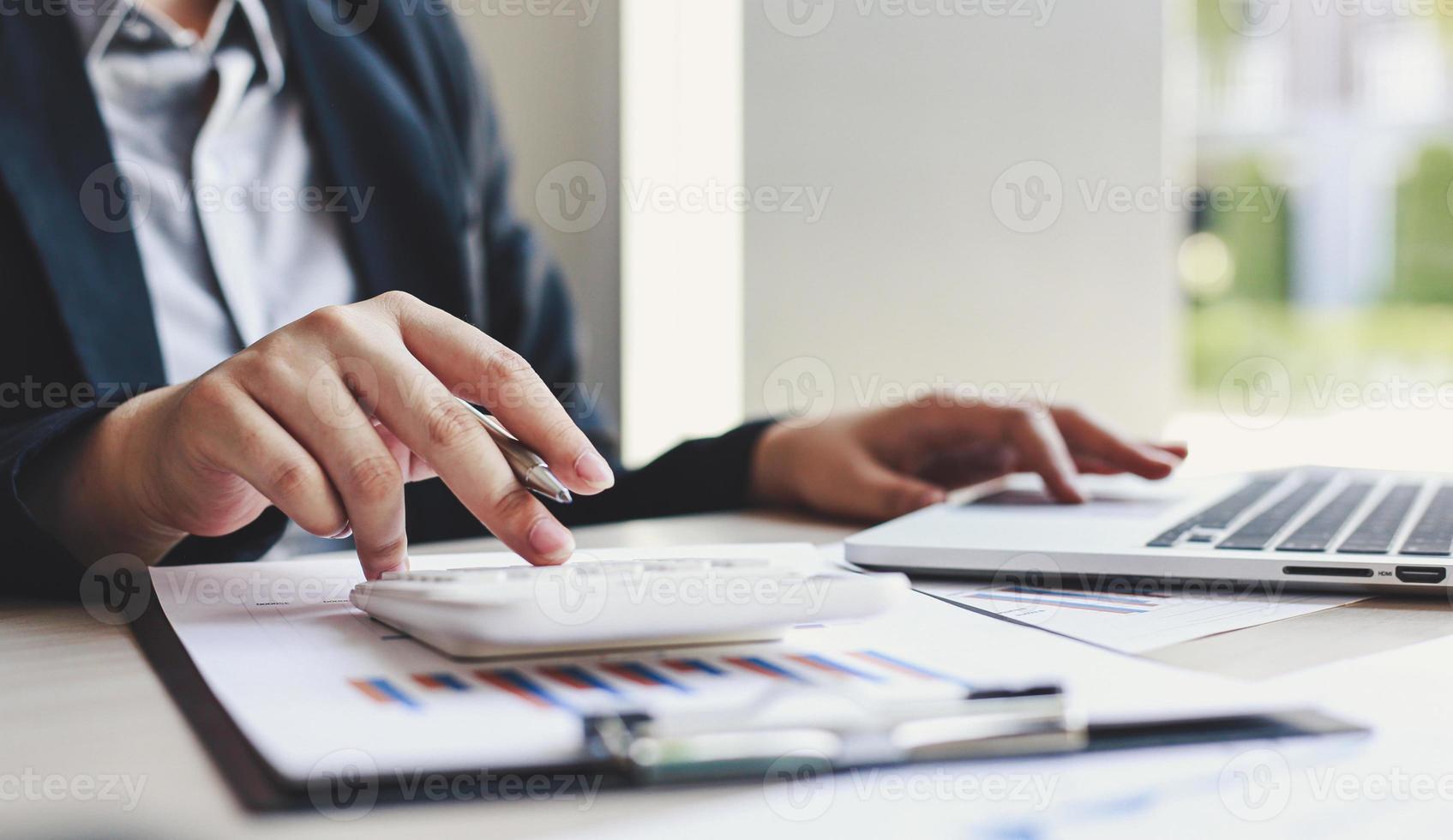 Accounting businessmen are calculating income-expenditure and analyzing real estate investment data, Dedicated to the progress and growth of the company, Financial and tax systems concept. photo