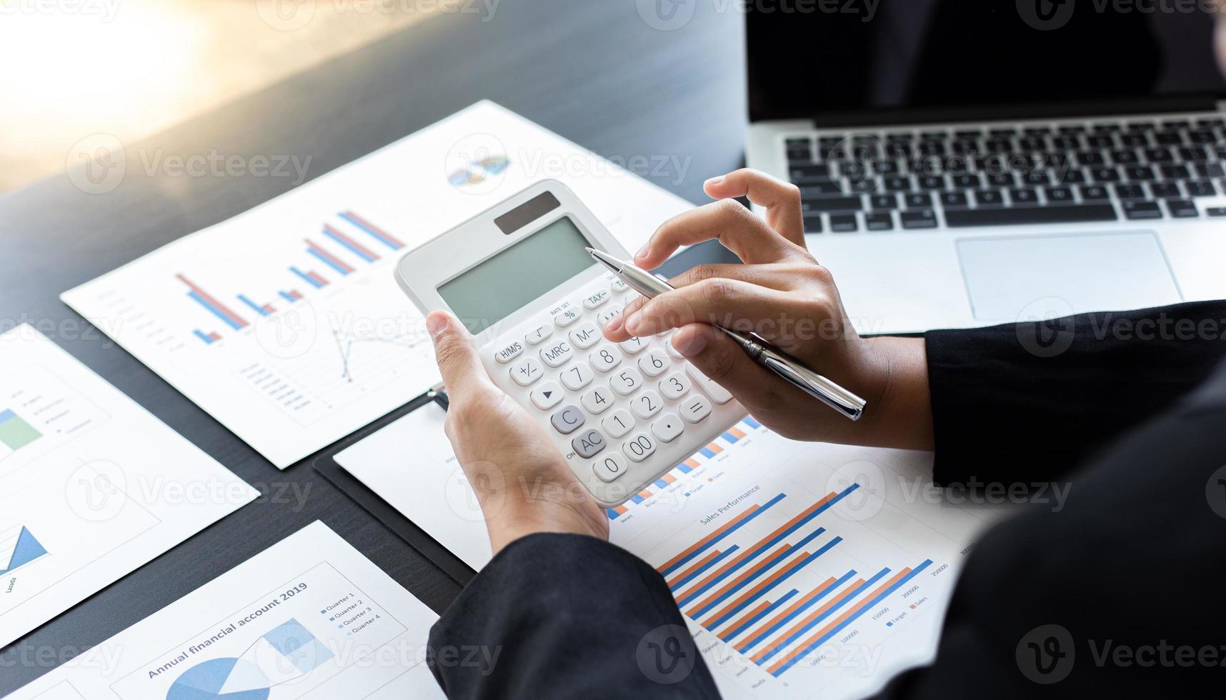 Accounting businessmen are calculating income-expenditure and analyzing real estate investment data, Financial and tax systems concept. photo