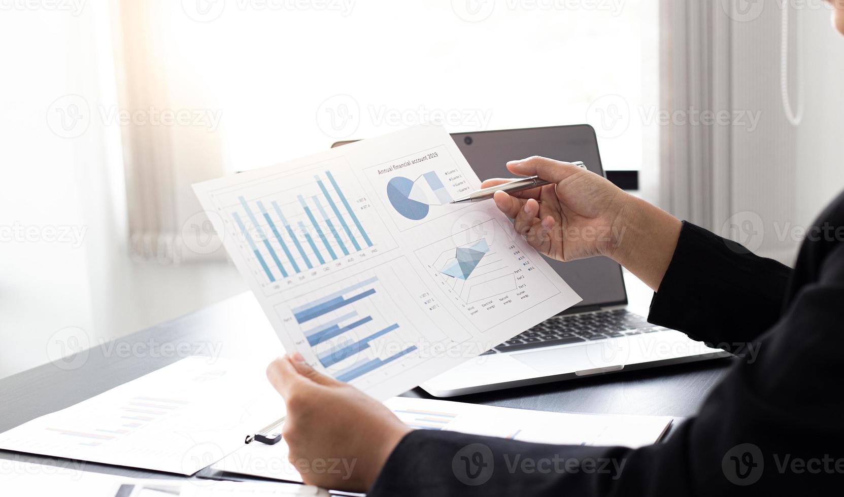 Financial businessmen analyze the graph of the company's performance to create profits and growth, Market research reports and income statistics, Financial and Accounting concept. photo