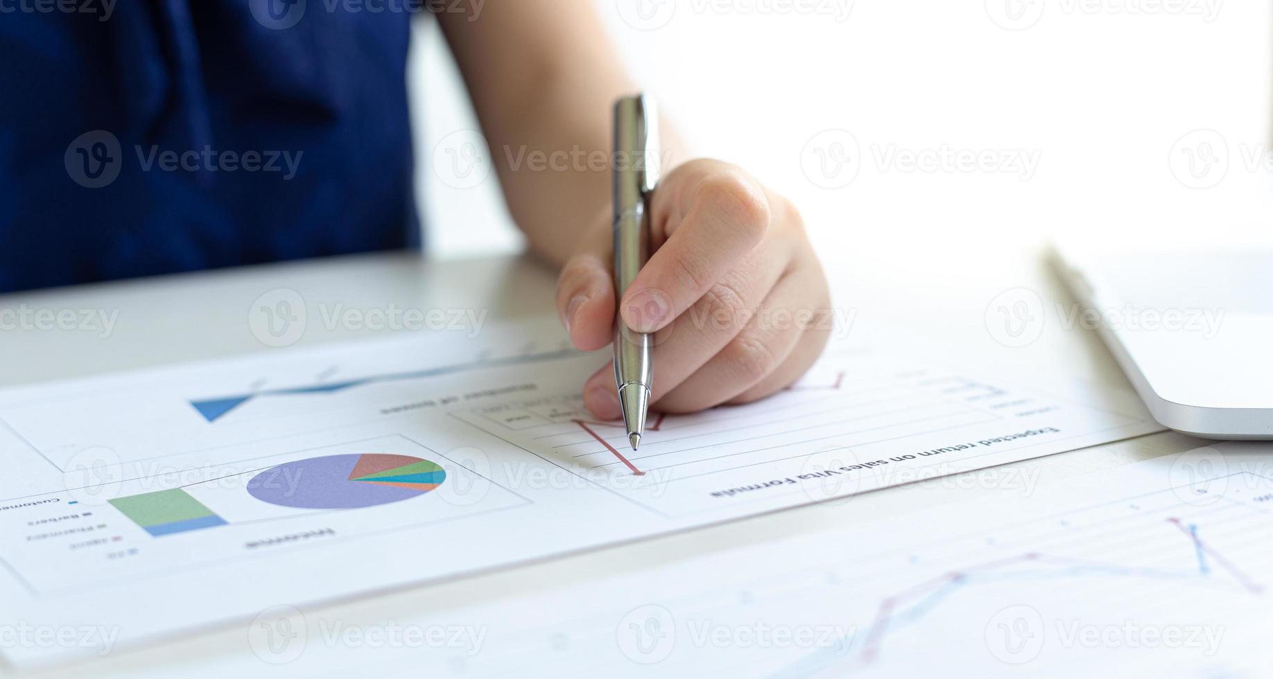 Financial businessmen analyze the graph of the company's performance to create profits and growth, Market research reports and income statistics, Financial and Accounting concept. photo
