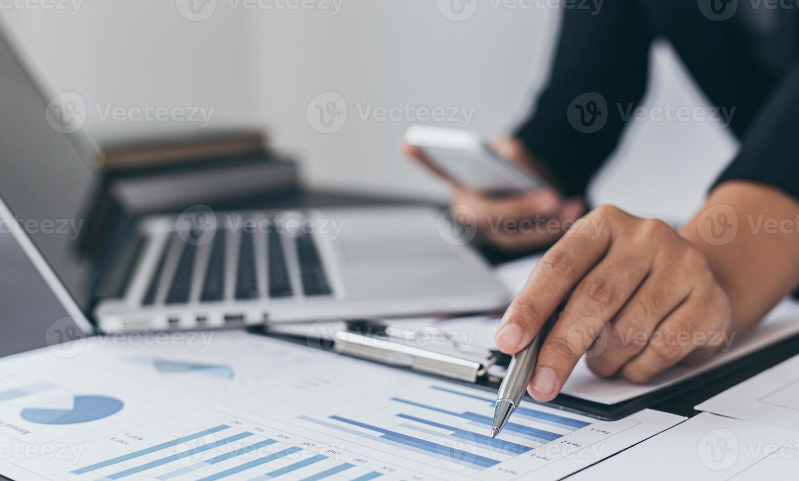 Financial businessmen analyze the graph of the company's performance to create profits and growth, Market research reports and income statistics, Financial and Accounting concept. photo