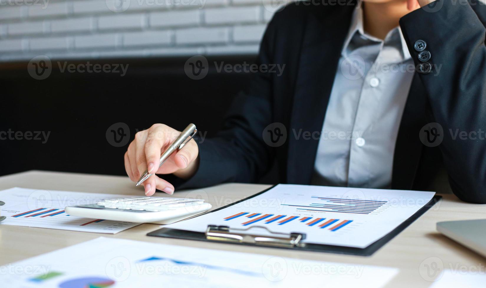 Accounting businessmen are calculating income-expenditure and analyzing real estate investment data, Dedicated to the progress and growth of the company, Financial and tax systems concept. photo