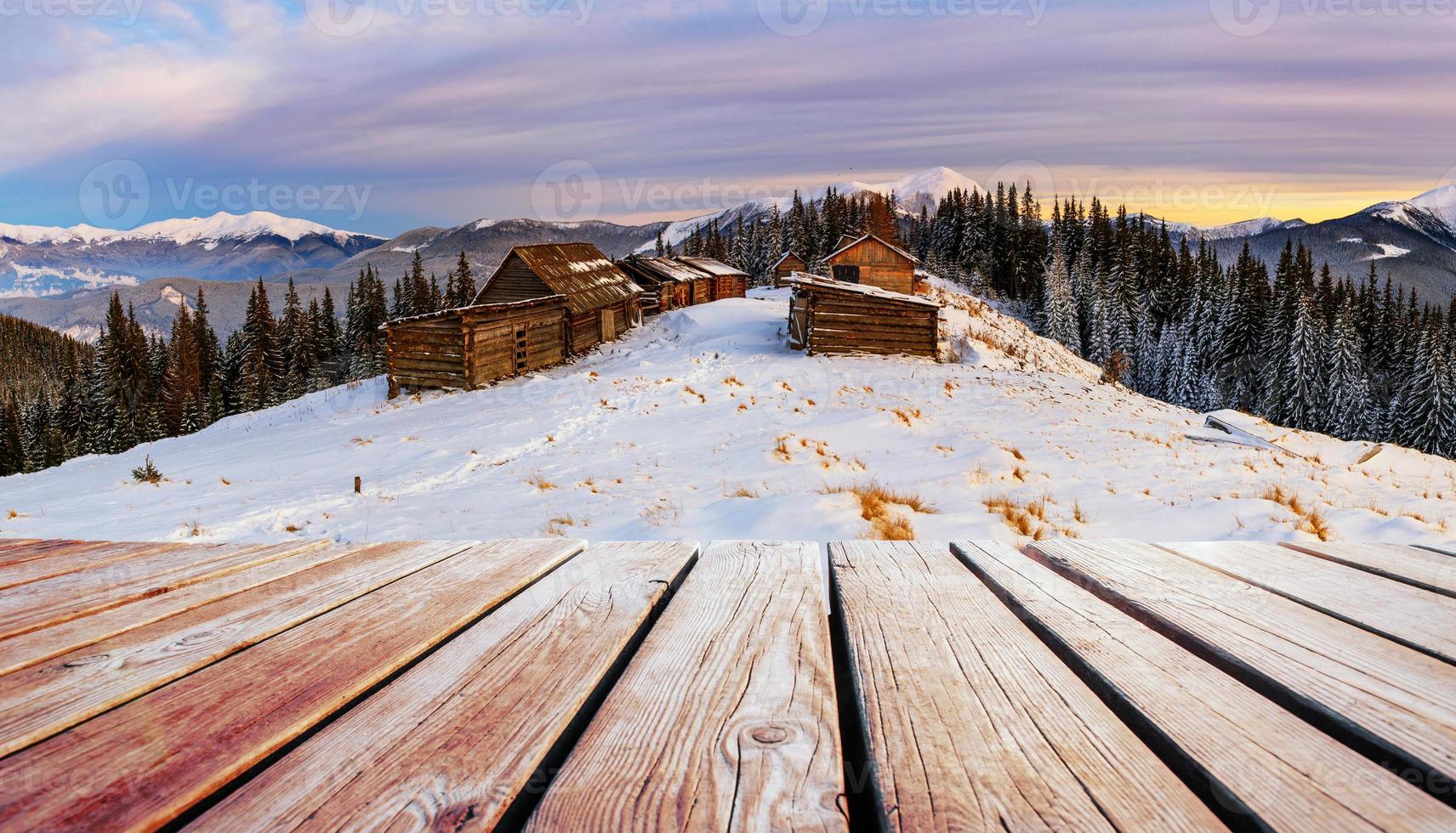 winter mountains landscape with a snowy forest and  wooden hut photo