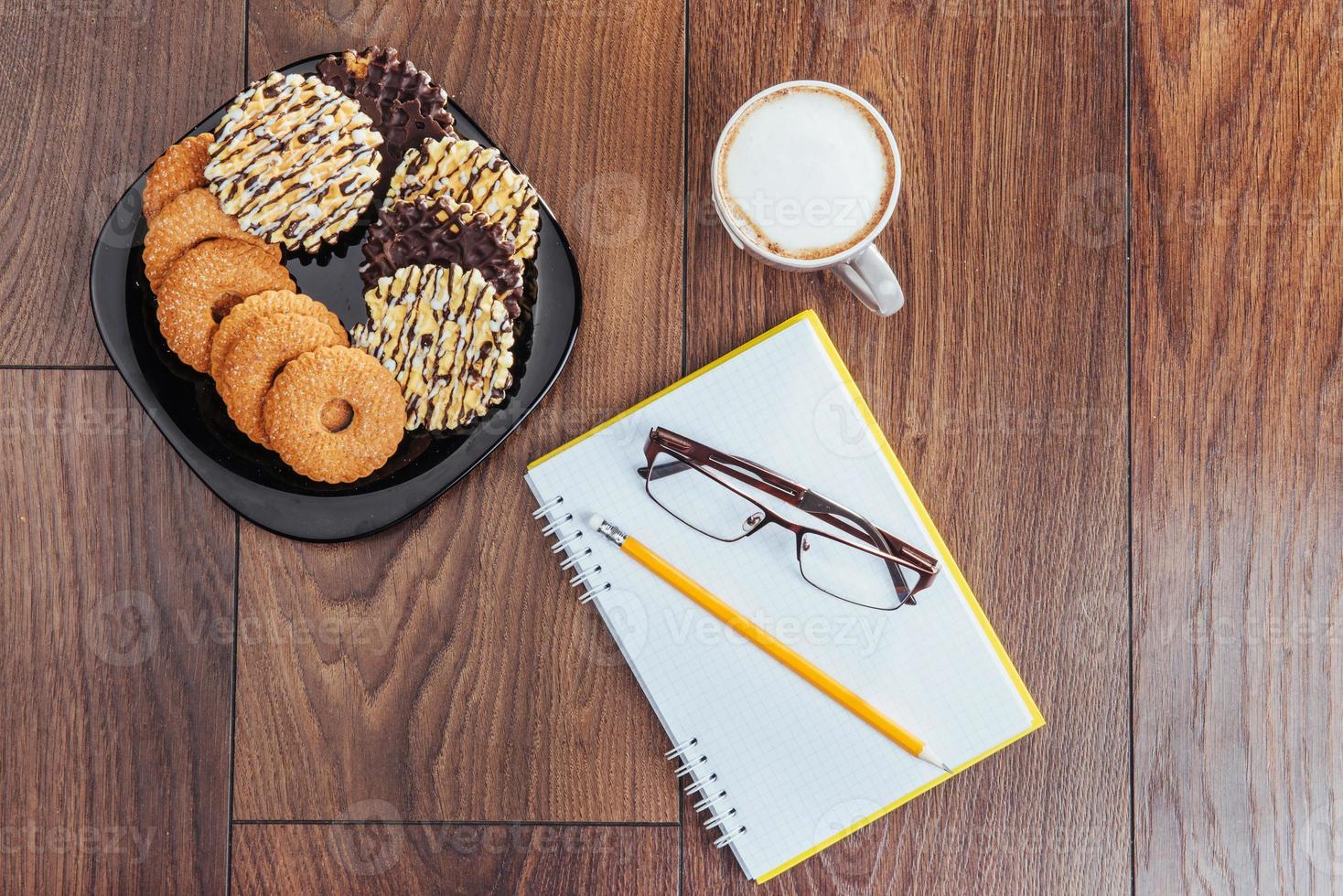 Top view of notebook, stationery, drawing tools and a few cups coffee. photo