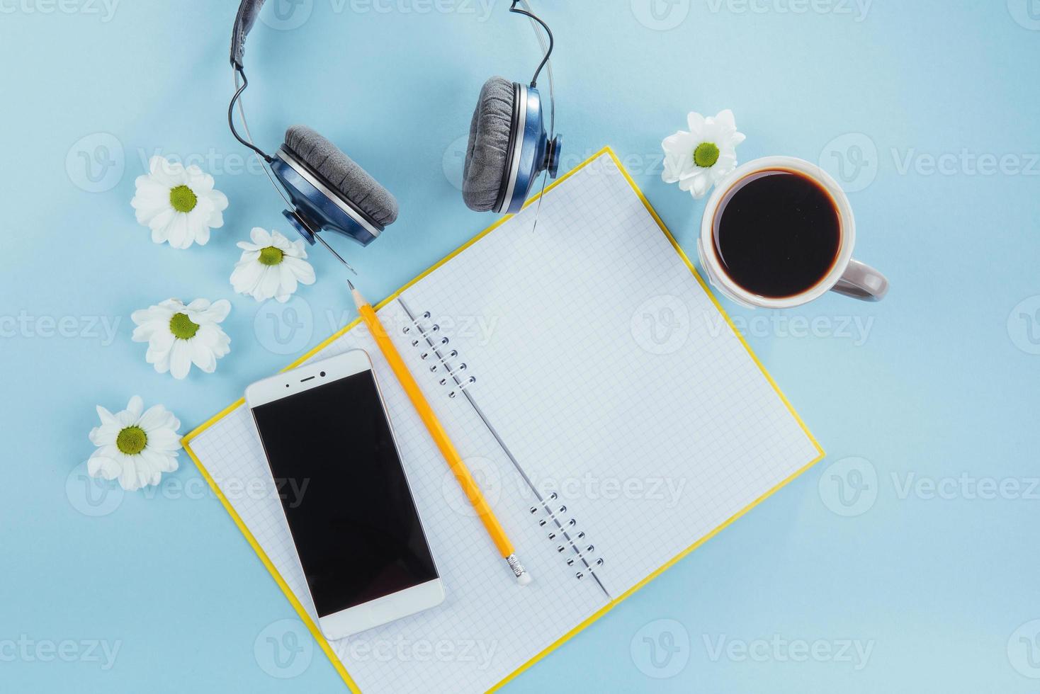 On the blue background notebook pencil, ruler and white flowers photo