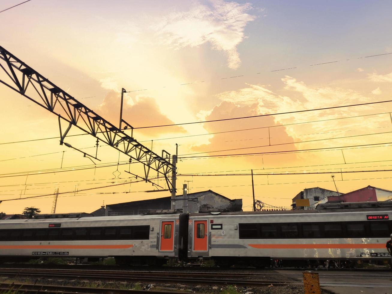 A train crossing the tracks under the twilight sky photo