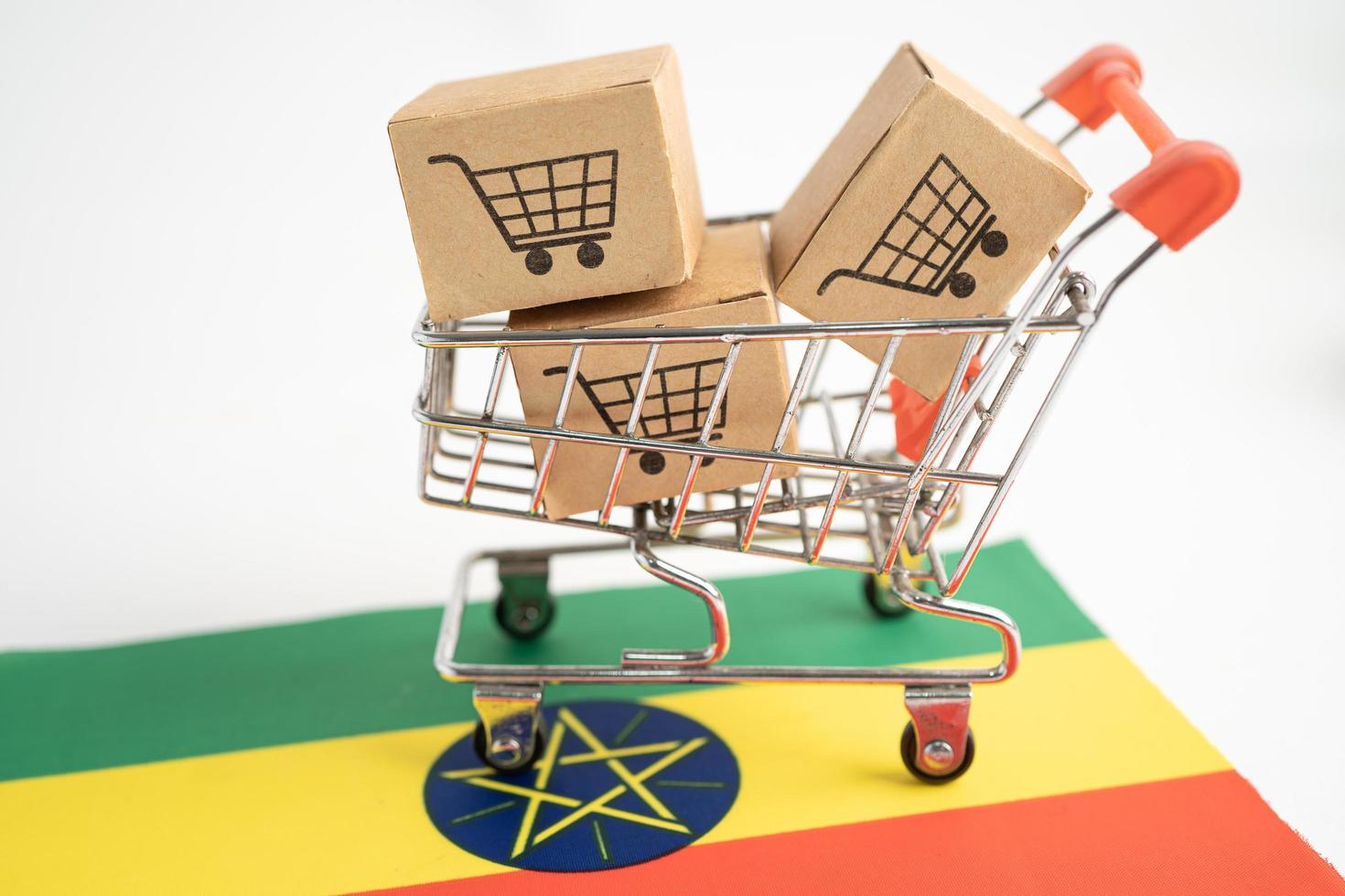 Box with shopping cart logo and Ethiopia flag, Import Export Shopping online or eCommerce finance delivery service store product shipping, trade, supplier concept. photo