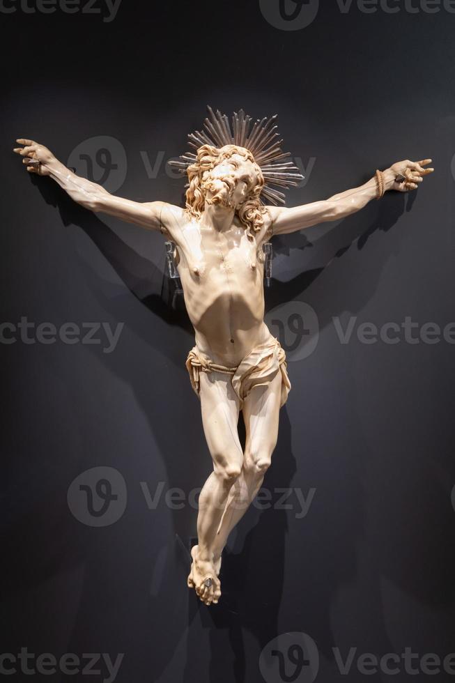 Jesus Christ - Old crucifix, Catholic Church, on black background with copy space. photo