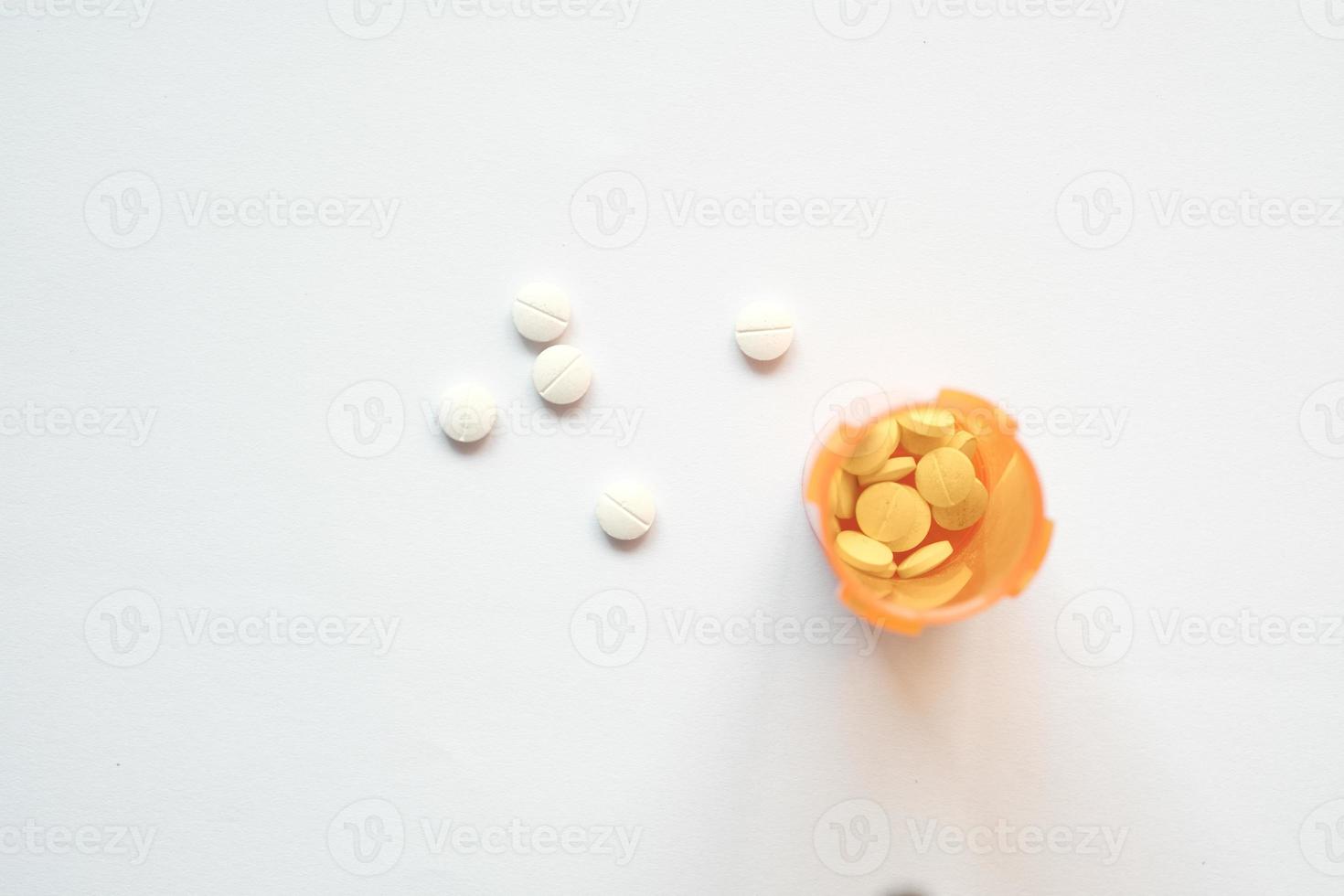 white color medical pills spilling on white background photo