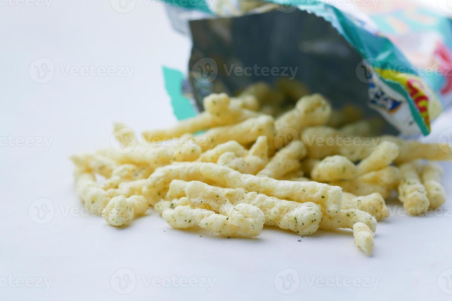 tasty potato chips in a packet on white photo