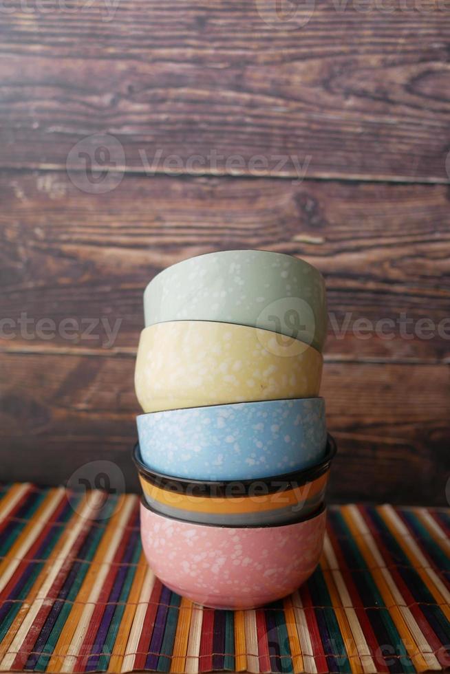 stack of colorful empty bowl on table photo