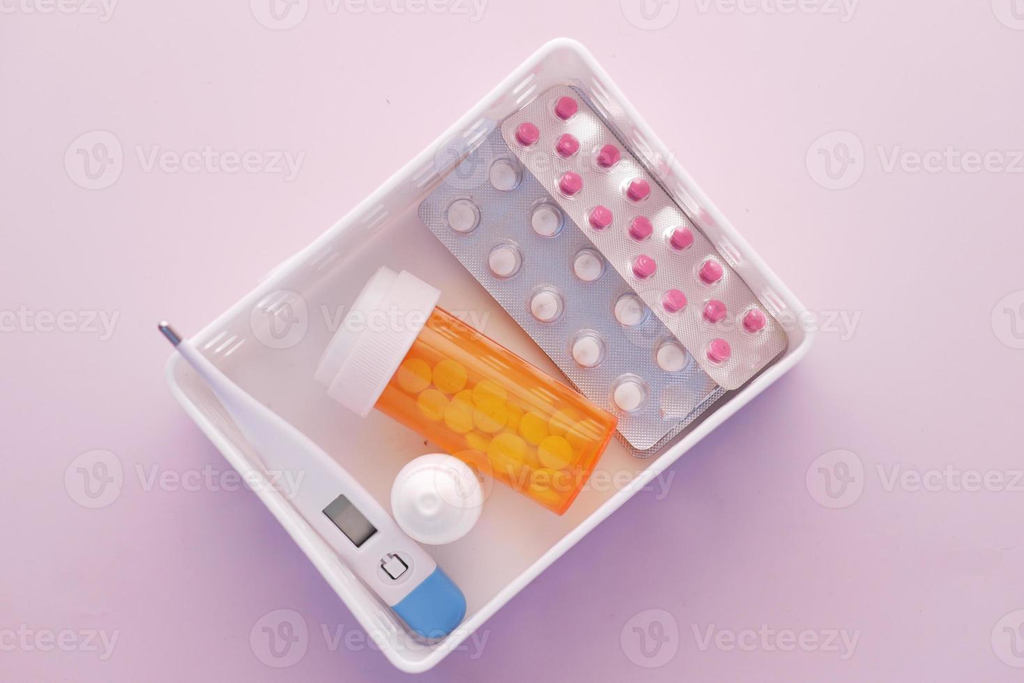 blister pack thermometer, container in a box on table photo