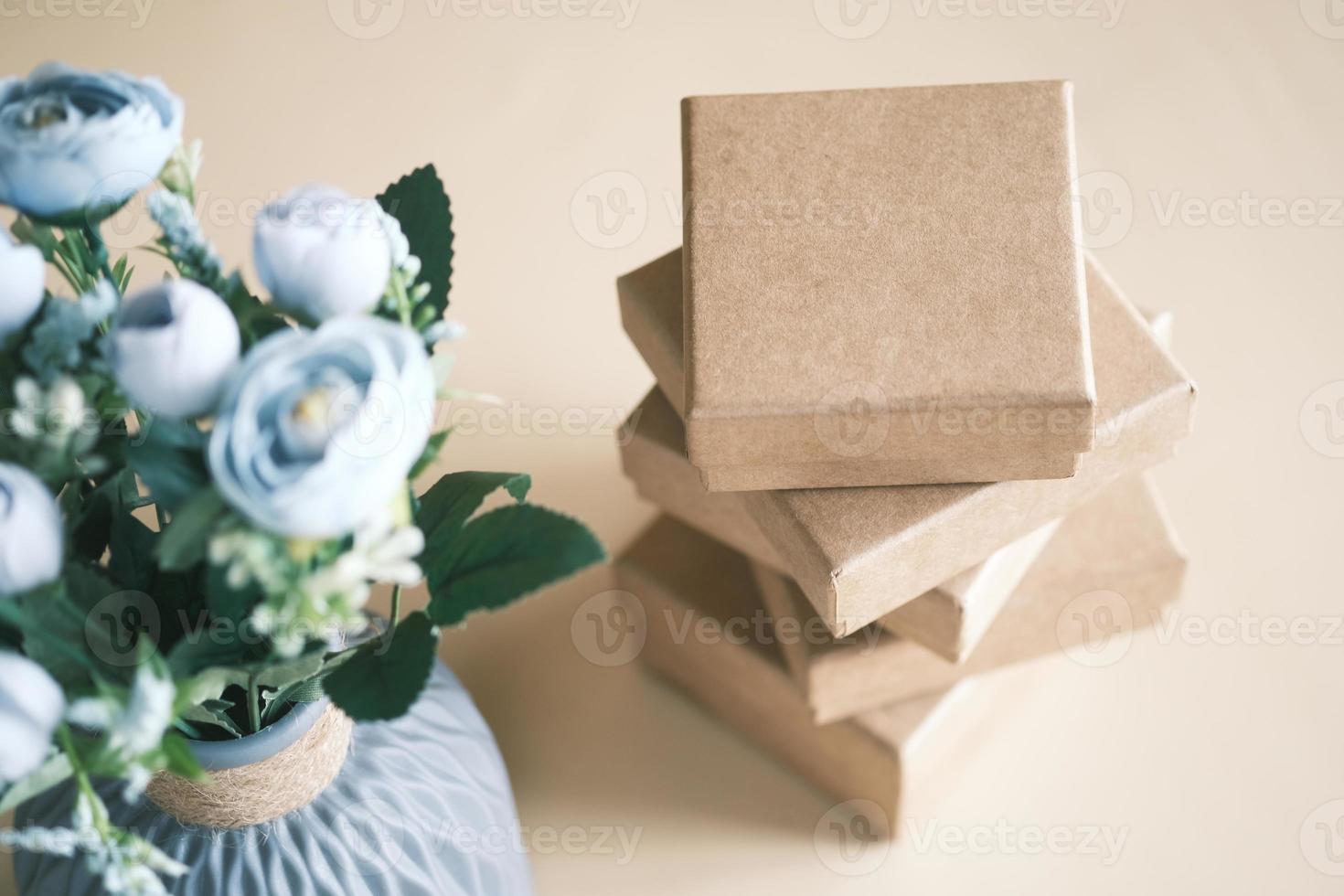 close up of crafter gift box and flower on table photo