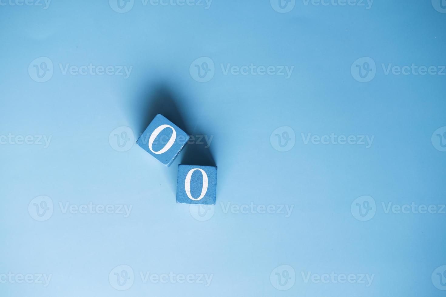 number zero on wooden block on blue background photo