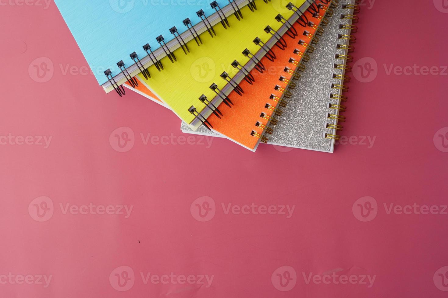 high angle view of colorful notepad on red background photo