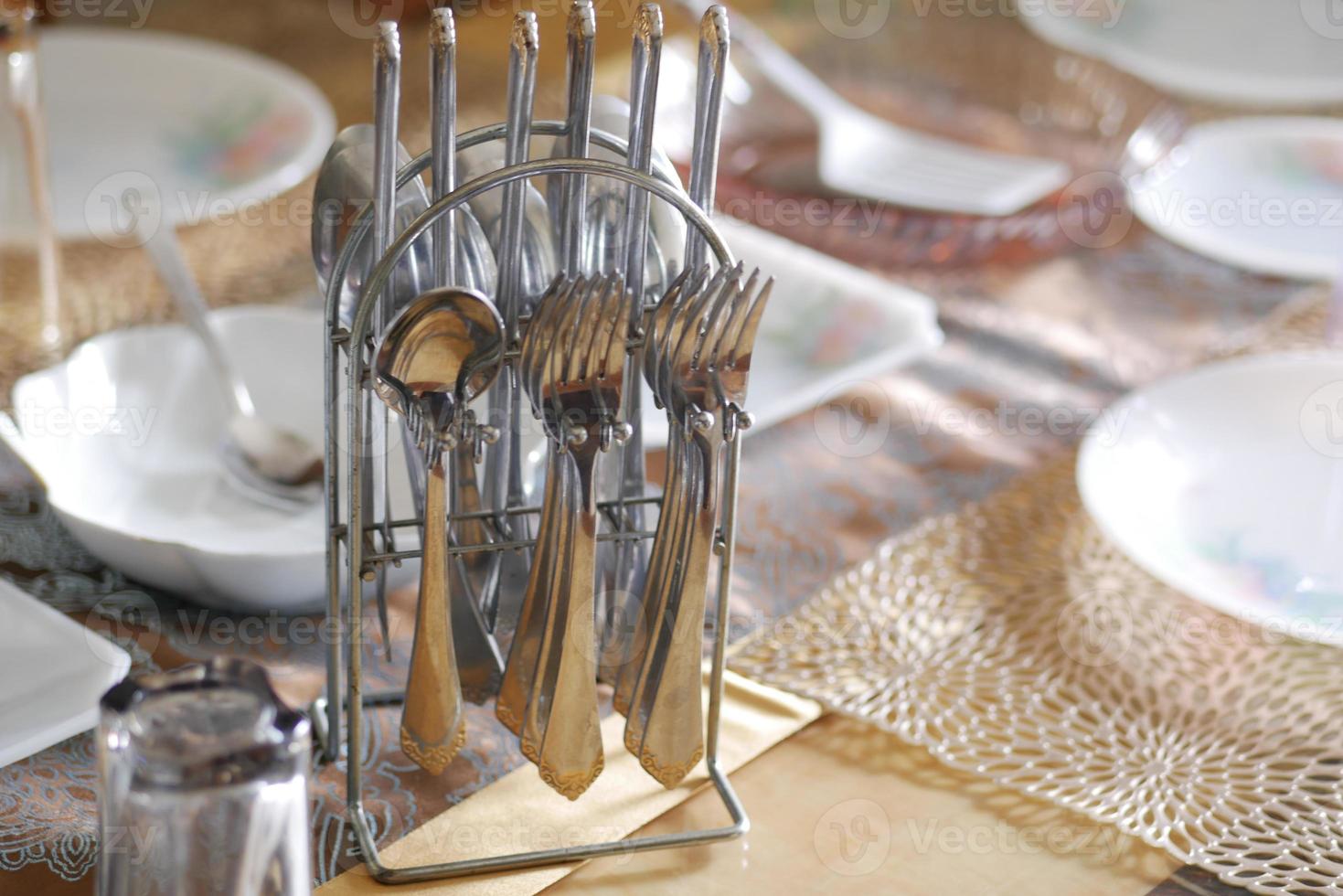 empty plate, table napkin with knife and fork on table. photo