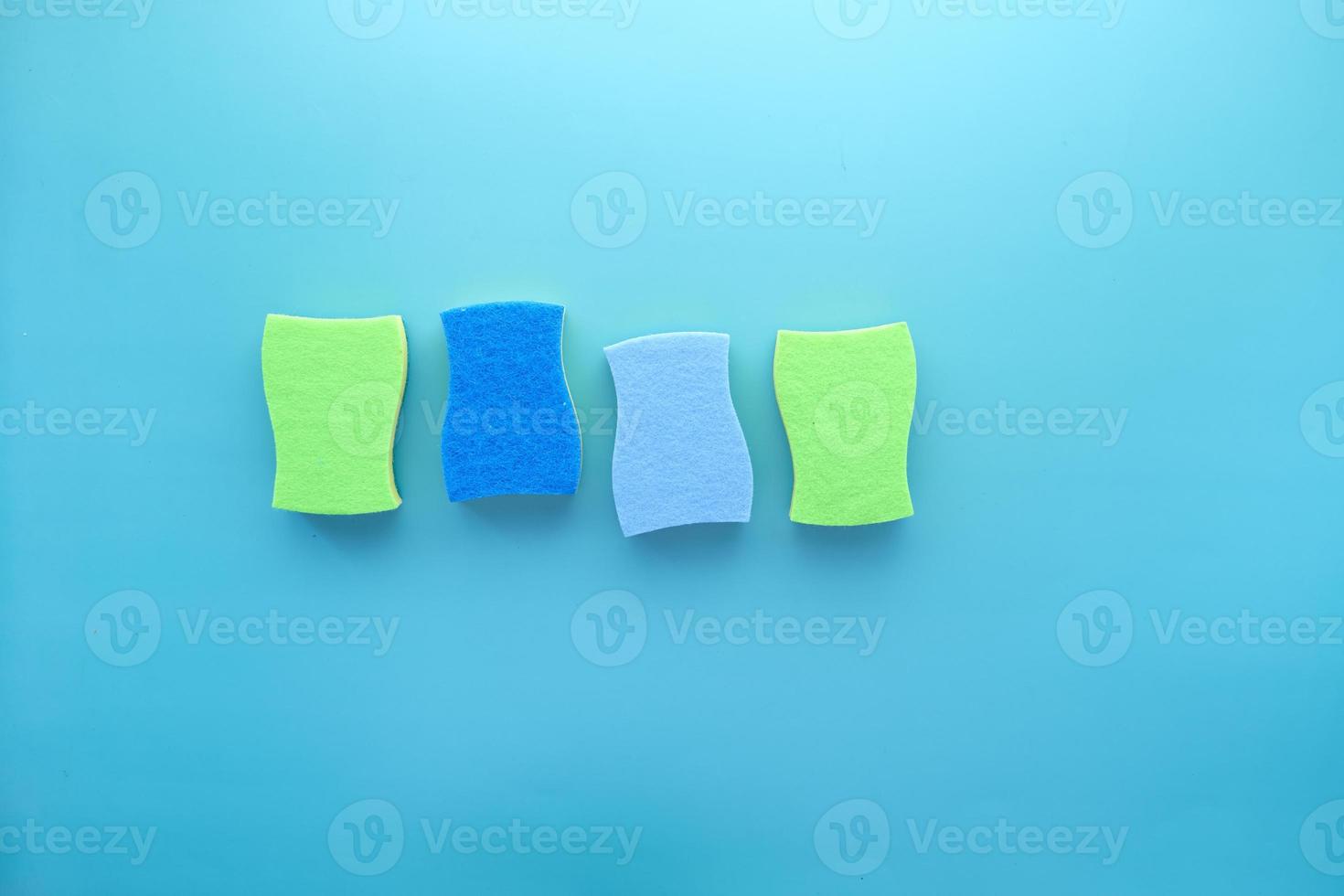 stack of sponge on blue background with copy space photo