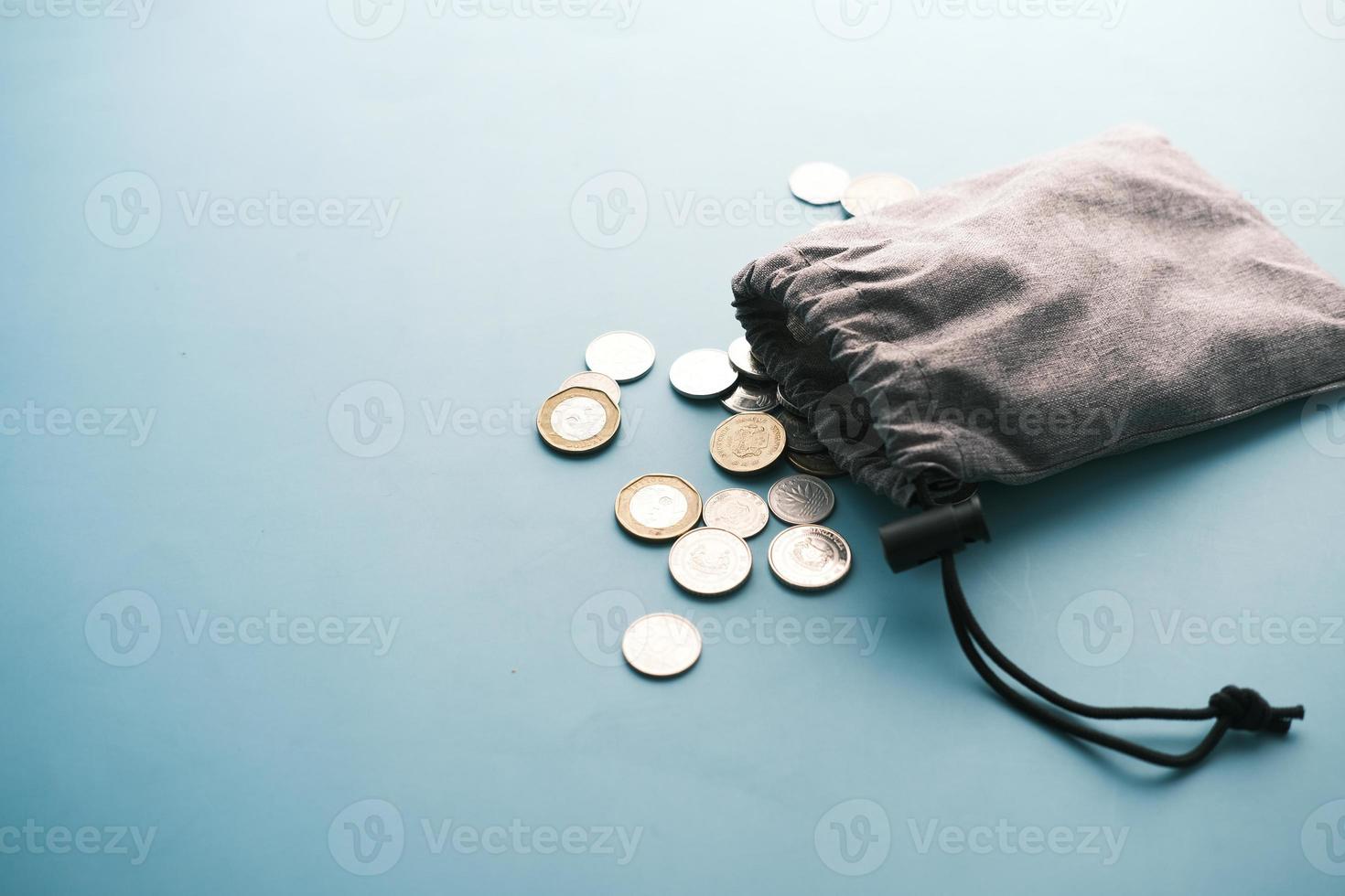 top view of coins spilling from a small bag photo