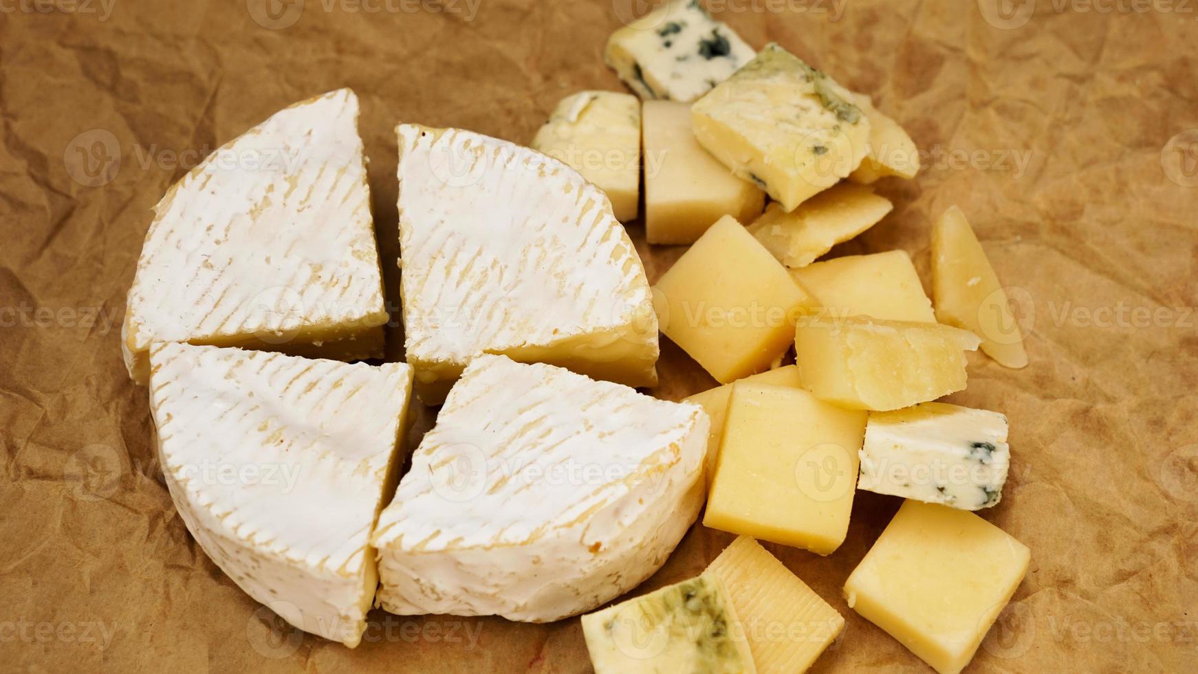 Different varieties of cheese. Soft french cheese of camembert and other types photo