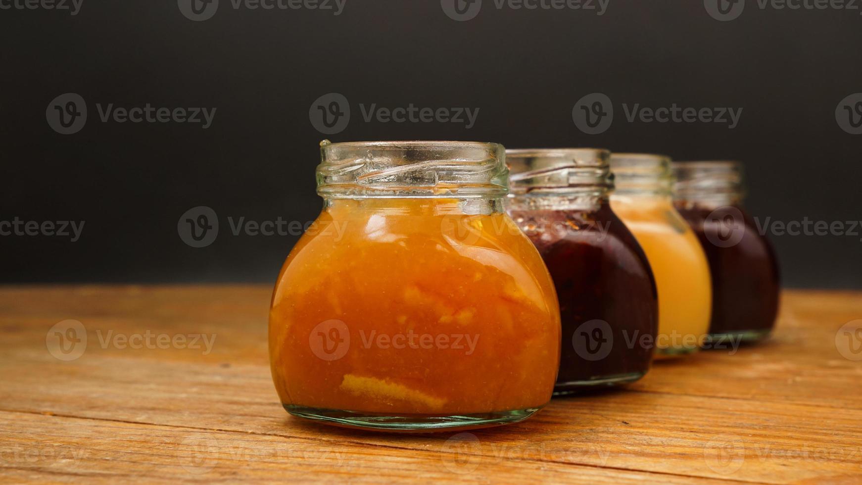 Home-made jam, selective focus. Jars with marmalade, confiture. Sweet dessert photo