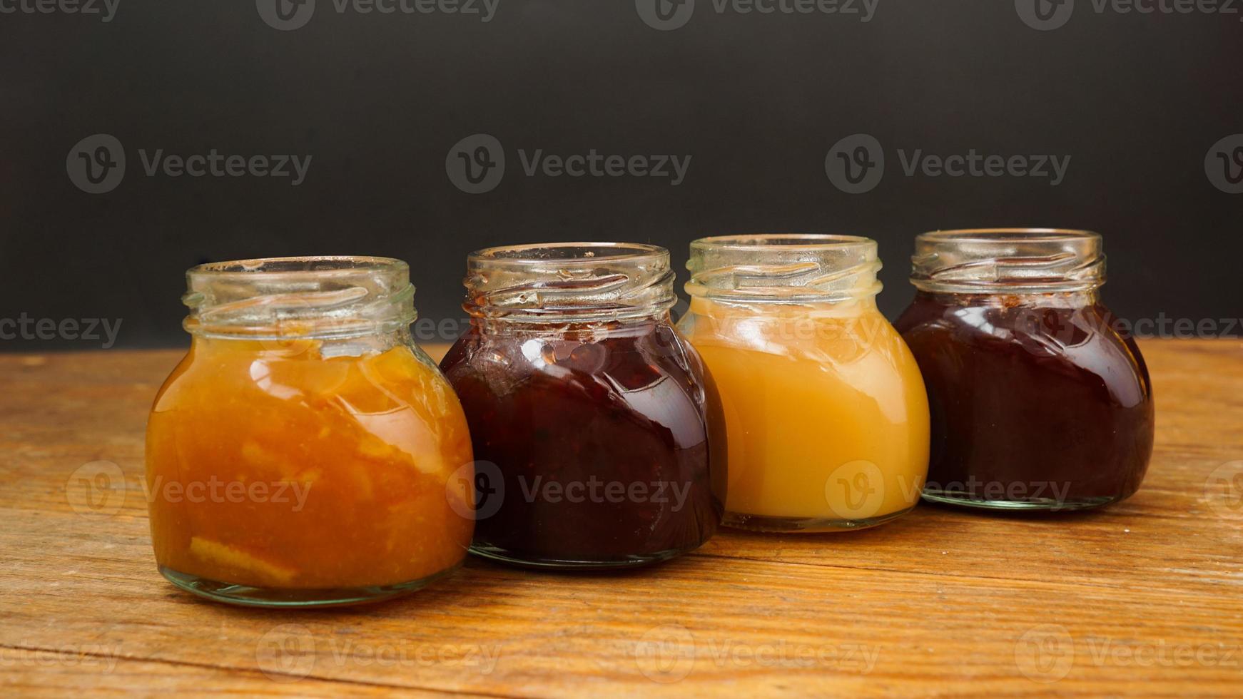 Home-made jam, selective focus. Jars with marmalade, confiture. Sweet dessert photo