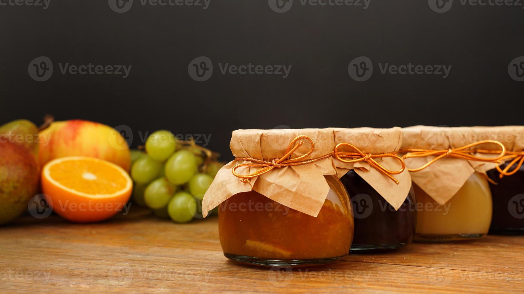 Home-made jam, selective focus. Jars with marmalade, confiture. Sweet dessert photo