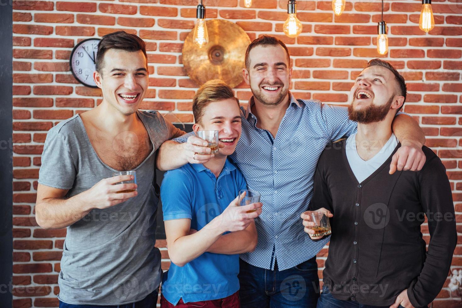 Cheerful old friends communicate with each other  glasses of whiskey in pub. Concept  entertainment and lifestyle photo