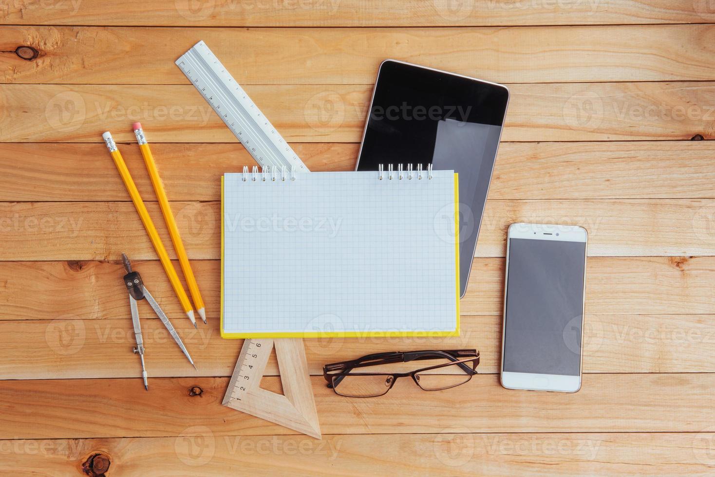 Top view of notebook, stationery, drawing tools and a few glasses. improvise. photo