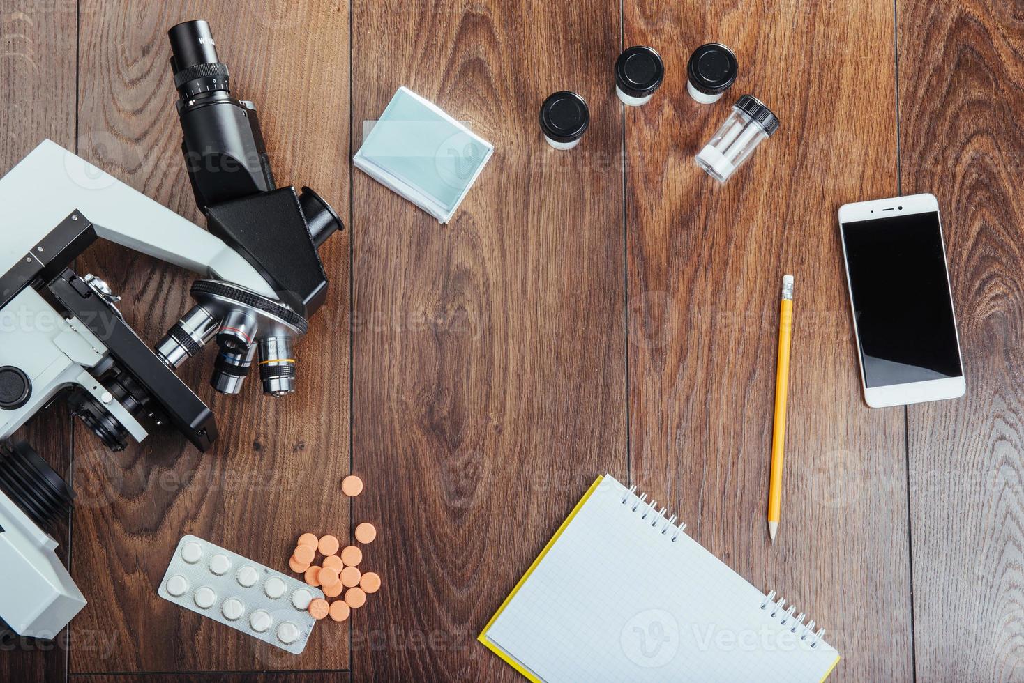 microscope image notebook and phone close-up. photo