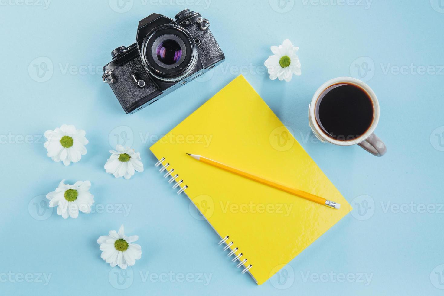 On the blue background notebook pencil, ruler and white flowers photo