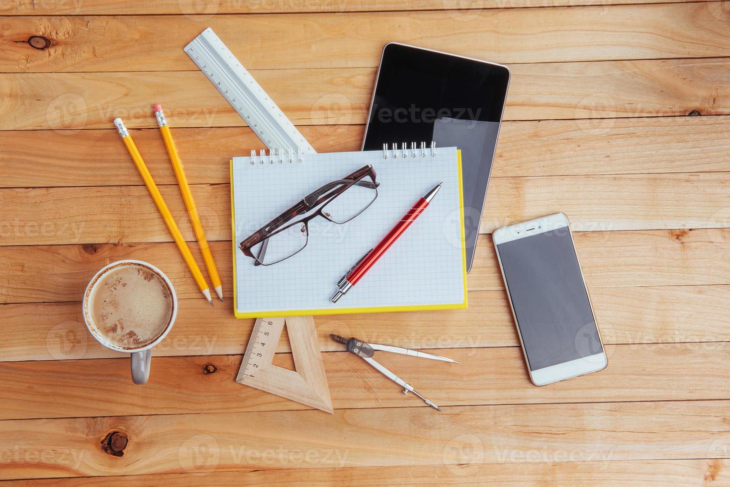 Top view of notebook, stationery, drawing tools and a few glasses. improvise. photo