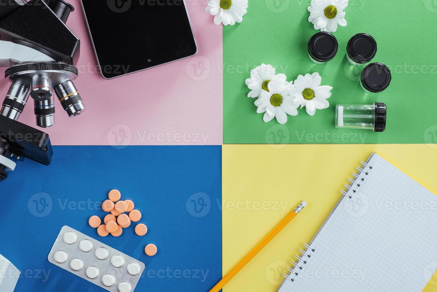 view from the mountain microscope with tablets and notebook on a colored background. photo