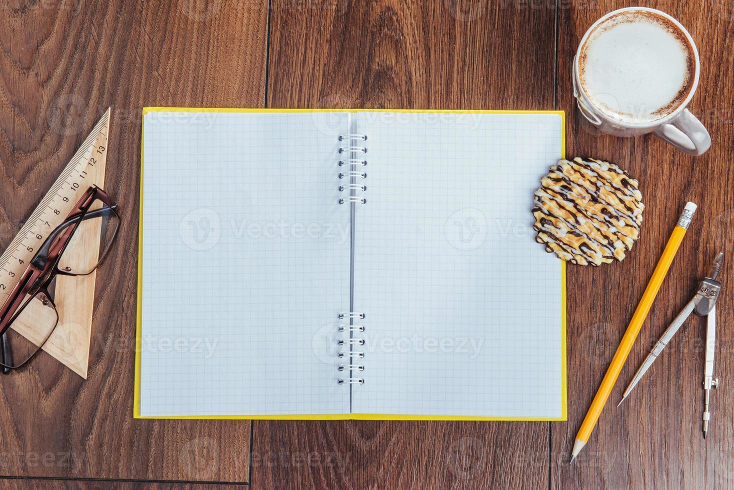 Top view of notebook, stationery, drawing tools and a few cups coffee. photo