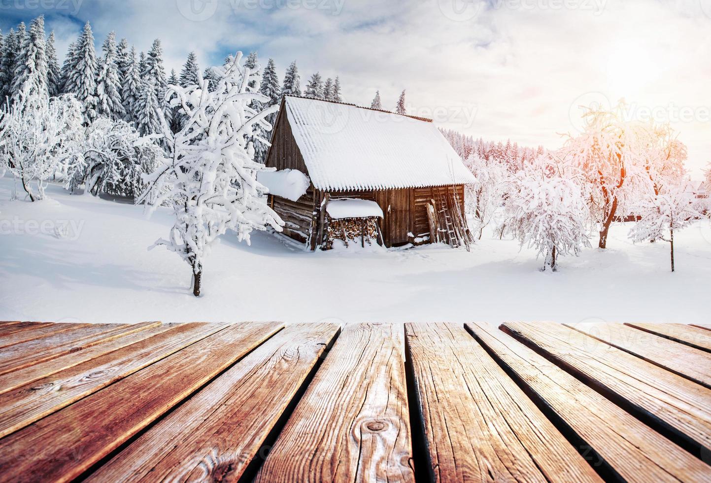 winter mountains landscape with a snowy forest and  wooden hut photo