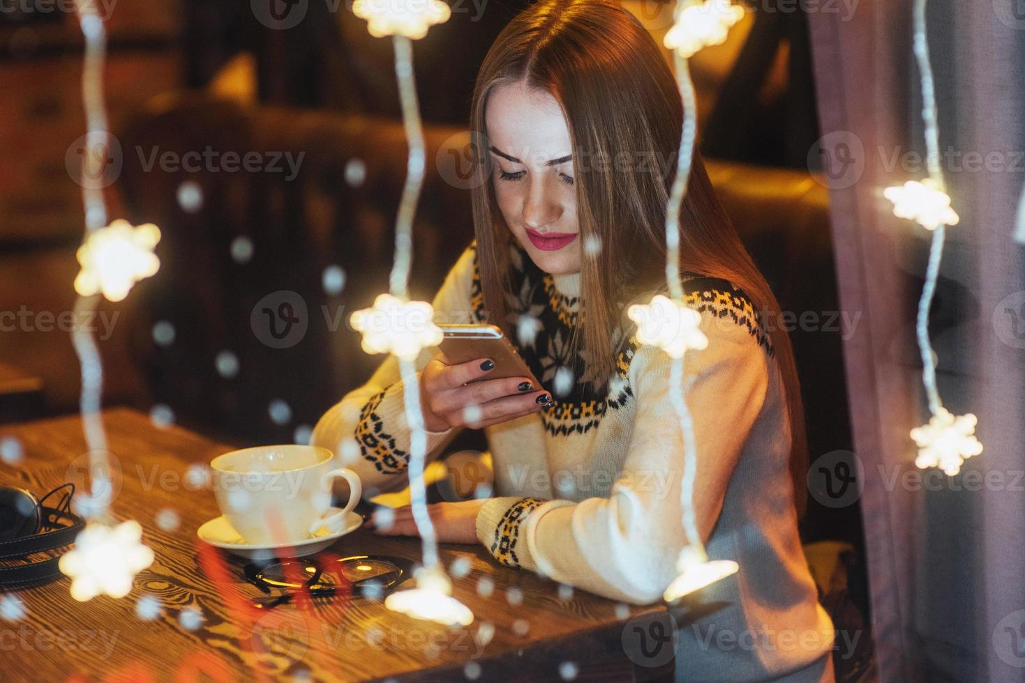 Young beautiful woman sitting in cafe, drinking coffee. Christmas, new year, Valentines day, winter holidays concept photo