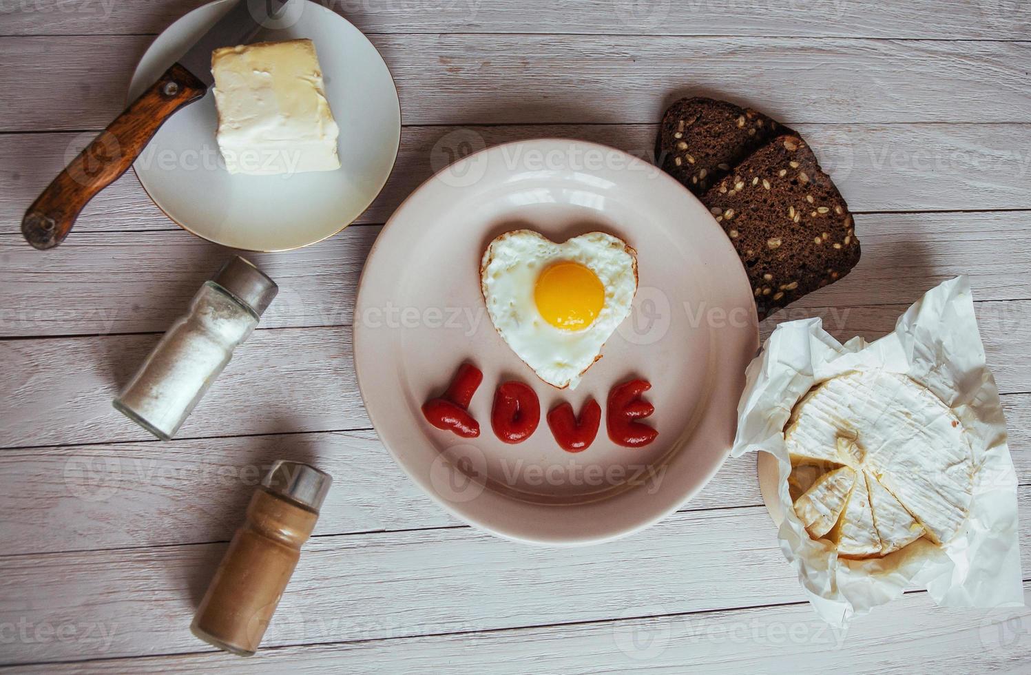 fried egg with ketchup and cheese brie. Tasty fragrant morning coffee photo