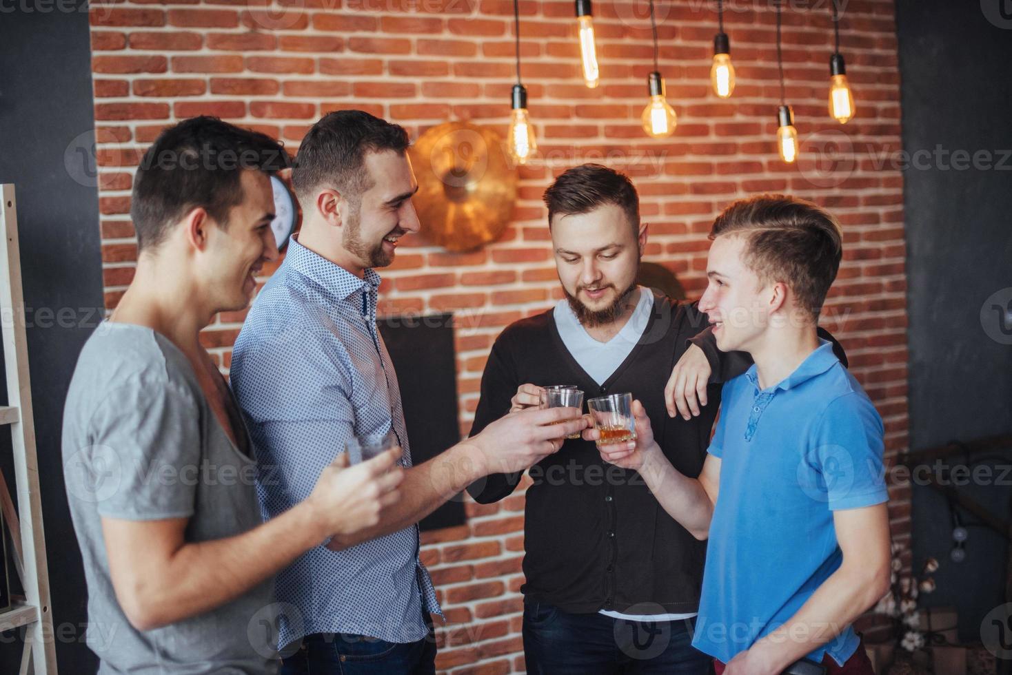 Cheerful old friends communicate with each other  glasses of whiskey in pub. Concept  entertainment and lifestyle photo