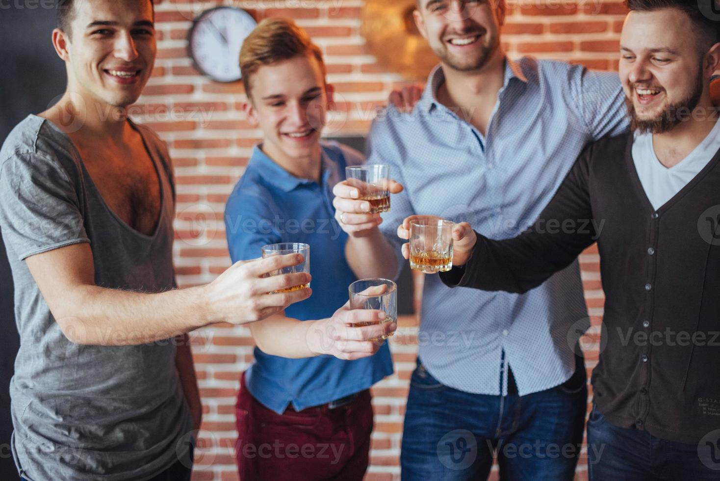 Cheerful old friends communicate with each other  glasses of whiskey in pub. Concept  entertainment and lifestyle photo