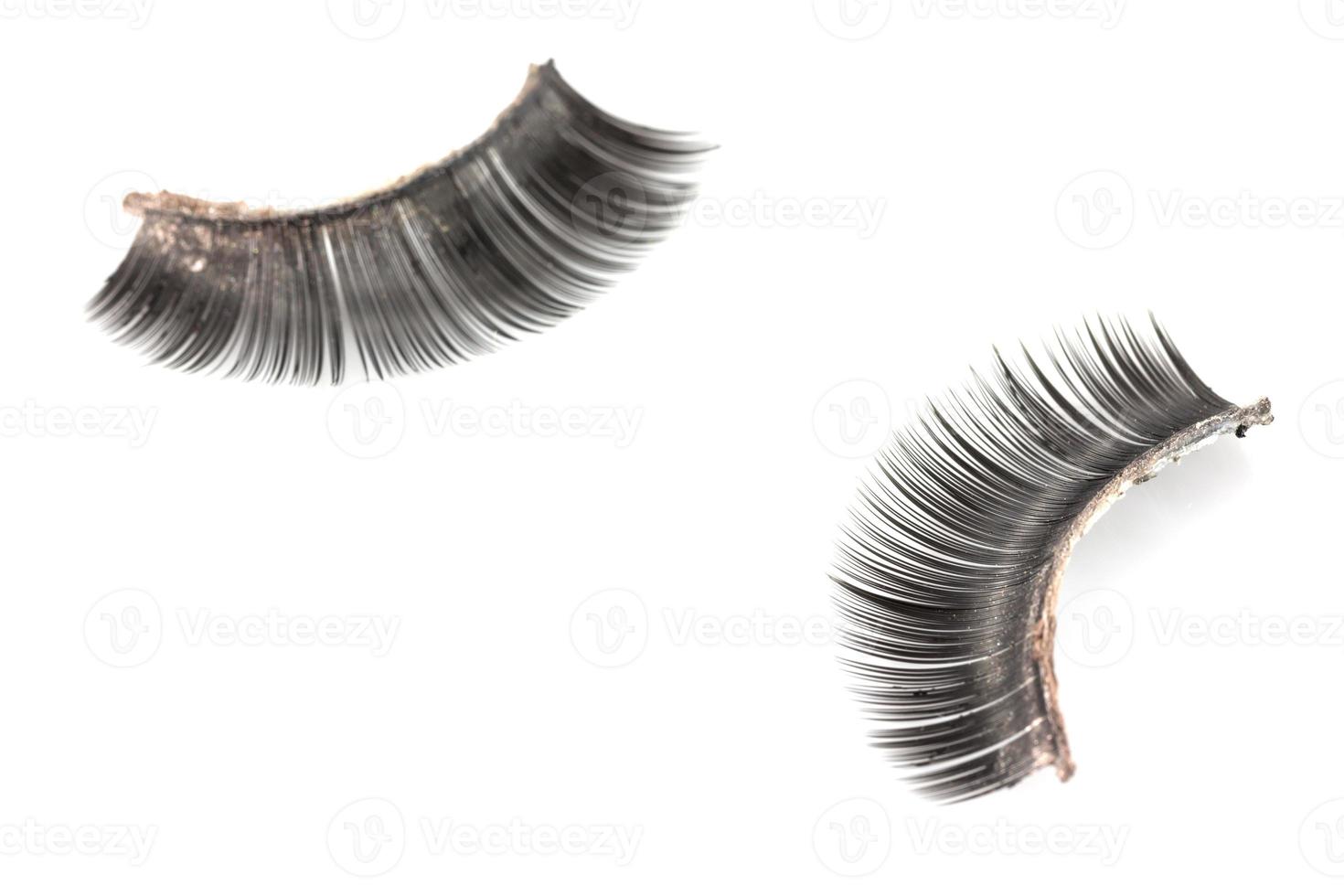 Use of  artificial eyelashes macro Isolated on white background photo