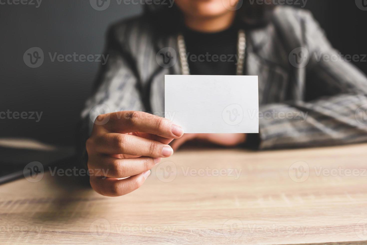 Business woman holding and showing white business card or blank card name in hands. Template for your design. Business card mock up photo