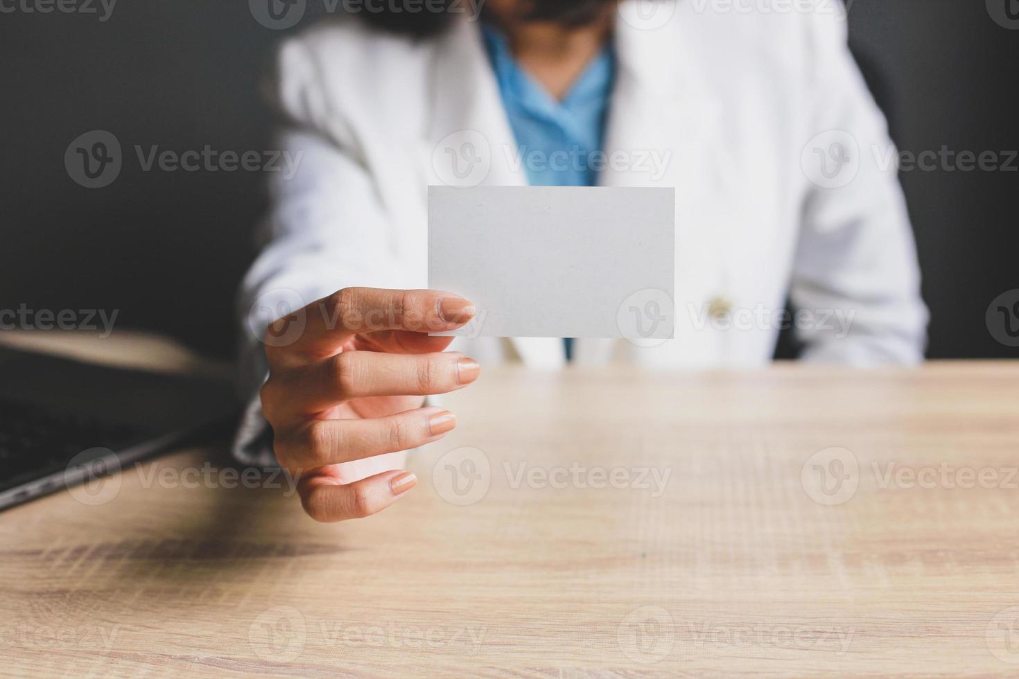 Business woman holding and showing white business card or blank card name in hands. Template for your design. Business card mock up photo