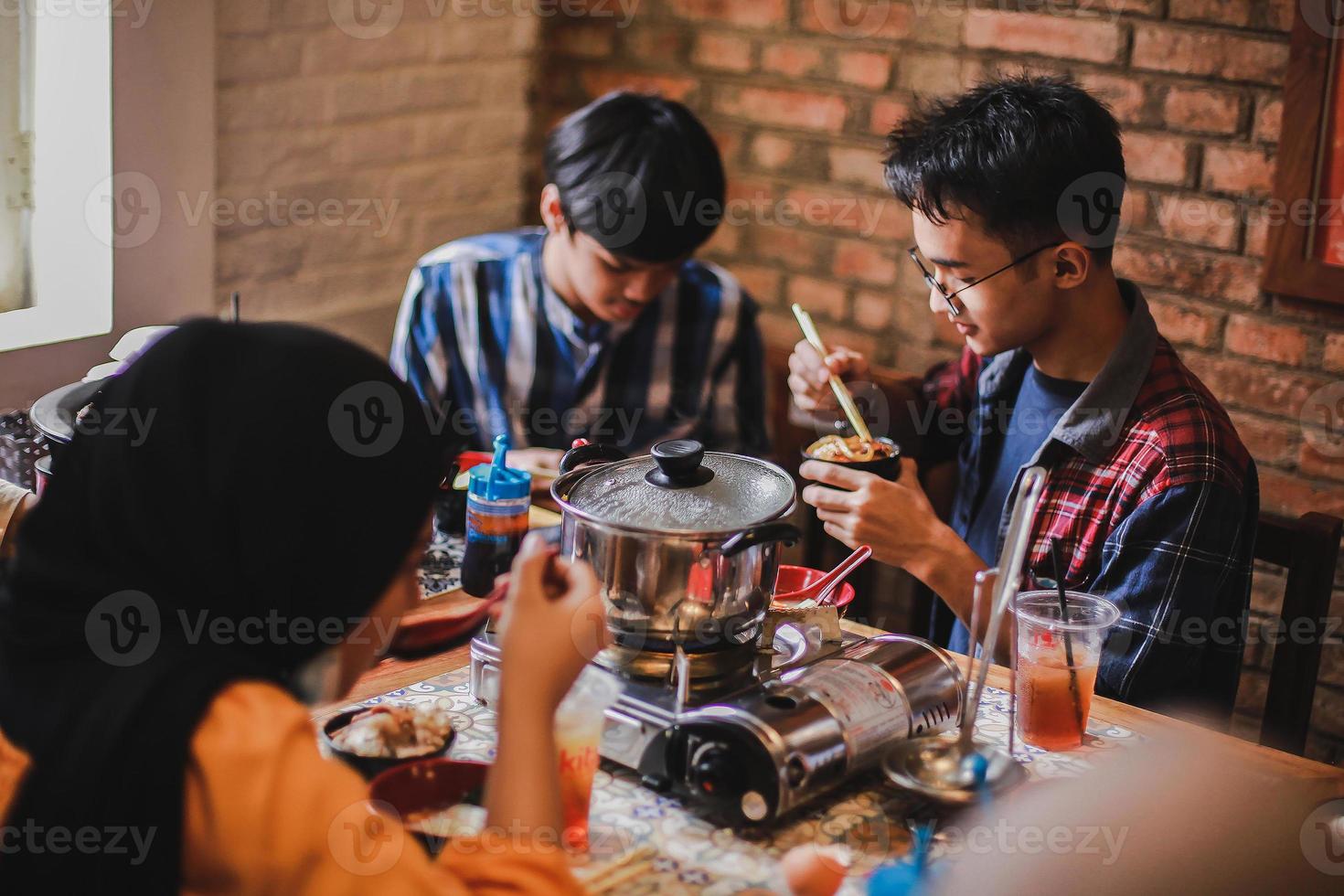Group of friends eating together at the barbecue party. Food, people and family time concept. photo