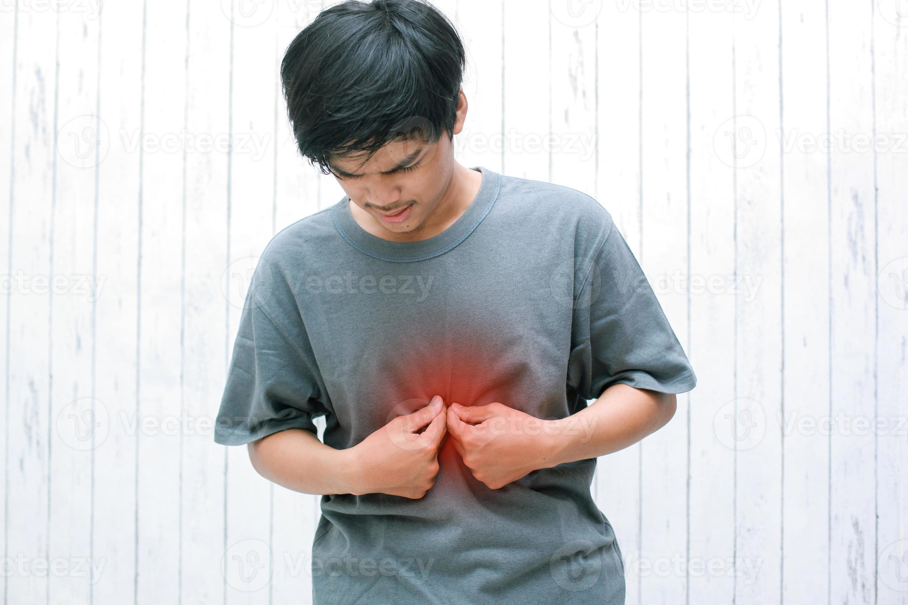 Young asian have symptoms of burning sensation in the middle of the